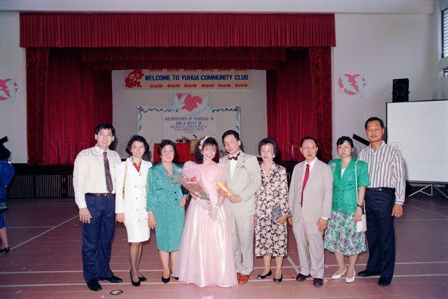 Solemnisation of Marriage at Yuhua Community Club - Group photo of bride and groom with guests.