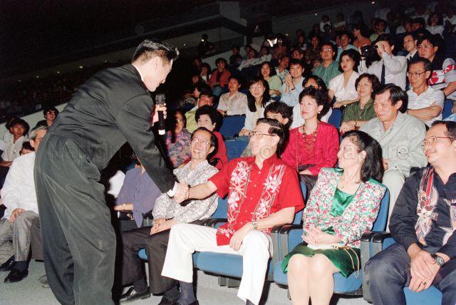 Panasonic Pan-Singapore Karaoke 91 at the Indoor Stadium - Contestant shaking hands with Deputy Prime Minister Ong Teng Cheong, with Members of Parliament Goh Chee Wee, Othman Bin Haron Eusofe and Zulkifli Bin Mohamed seated in the audience.