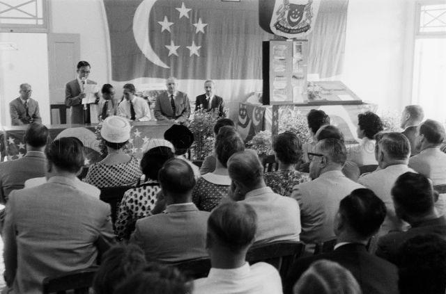 Parliamentary Secretary to the Prime Minister, Chan Sung Wing delivering a speech at St James Power Station, with Minister for Finance Goh Keng Swee seated in the background