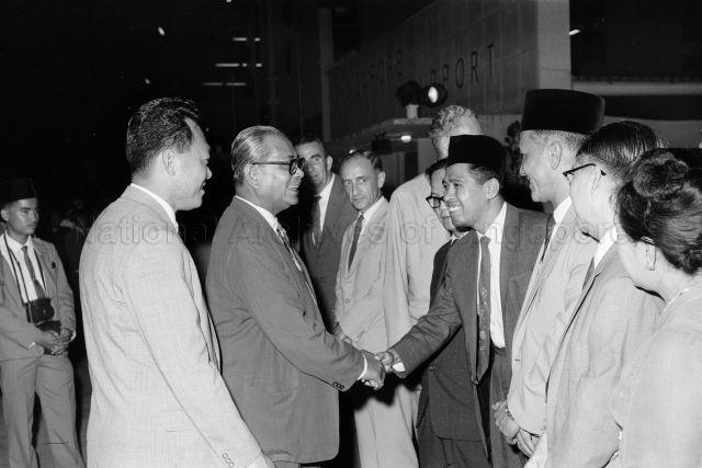 Malaysian Prime Minister's Visit to Singapore - Prime Minister of Malaysia Tunku Abdul Rahman shaking hands with officials, accompanied by Prime Minister Lee Kuan Yew