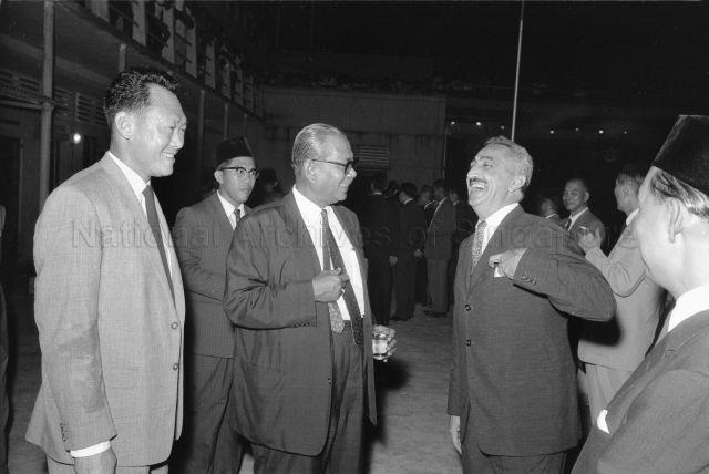 Malaysian Prime Minister leaving for London - Malaysian Prime Minister Tunku Abdul Rahman having a conversation with guests, accompanied by Prime Minister Lee Kuan Yew