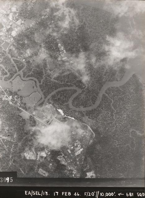 Aerial photo showing the mangrove forests at the Sungei Serangoon estuary. The creek snaking its way through the mangroves, with a big U-shaped bend, is Sungei Blukar. Below Sungei Blukar is a pipeline and light railway leading to the Sewerage Treatment Works, which is partly obscured by cloud.