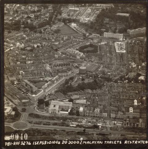 Shenton Way and Shenton Circus at bottom of photo with Robinson Road parallel running to Anson Circus. White building along Robinson Road was the CID Headquarters. From Anson Circus, Maxwell Road runs towards New Bridge Road, passing the Maxwell Post Office and Traffic Police Building (left of Maxwell Rd), passing the Gasworks and Maxwell Market (centre of photo).The (Singapore) General Hospital is at top left and Outram Prison at top centre with Pearl's Hill on top right.