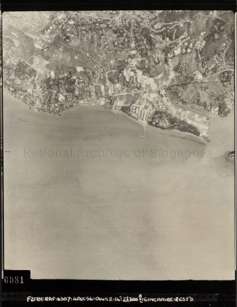 The straight road in the photo near to the edge of the sea is Pasir Panjang Road. Also shown is the junction of Pasir Panjang Road and Buona Vista Road. The area that is quite devoid of buildings is Pasir Panjang Hill (more commonly known as Kent Ridge today).