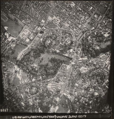 Aerial view of the Newton and Orchard area, Singapore. The roundabout (bottom left) shown near the edge of the photograph is Newton Circus, while in the centre is the Government House and its surrounding landscaped greenery, now known as the Istana, the present-day residence and office of the President of Singapore. The plateau-like landform on the right is Fort Canning Hill.