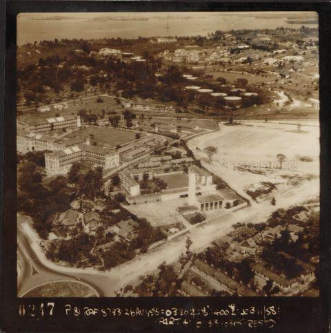 The Alexandra Fire Station (centre of picture) with the British Military Hospital (Alexandra Hospital) (middle left). The Normanton Oil Storage Depot at top right. Circus at bottom left is the Rumah Bomba Circus at Alexandra Road, with the future Queensway under construction in front of the fire station.