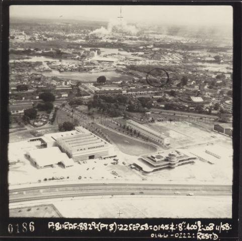 Aerial view of the old Kallang Airport in Singapore. The foreground shows Nicoll Highway, while the circular control tower can be seen beside the highway on the right.