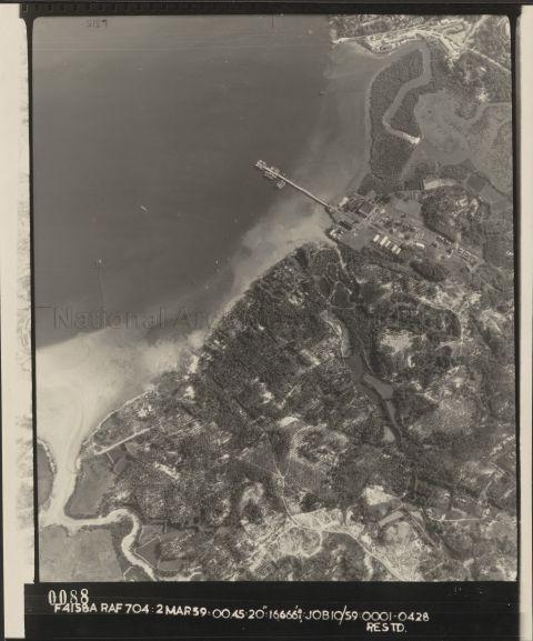 The area of Loyang and Kampong Loyang with Sungei Tampines at bottom left. The Loyang Jetty with Sungei Selarang on the right and Fairy Point at top of photo. The jetty and buildings behind it were in the compound of H.M. Naval Base B.D. Depot - Loyang. B.D. stood for Boom Defence, and the acronym for the Boom Defence Depot was BDO. Built in 1939-40 to defend the Seletar Naval Base (located at Sembawang) BDO Loyang had a long anti-submarine boom net that stretched from the BDO at Loyang to Pulau Ubin. The large hanger-like building with the corrugated roof to the right of the jetty was the boom store. The building to the left of the jetty was the mine store. The boom net had a gate in it that could be opened to allow friendly ships to pass through. &nbsp;At 0930 hours on 31 July 1945, two Royal Navy midget submarines, HMS XE3 and HMS XE1, slipped through the gate of the boom defence at Loyang, that the Japanese had carelessly left open, and made their way to the Seletar Naval Base, where they laid limpet mines and timed demolition charges under the Japanese cruiser Takao, which had been damaged in the battle of Leyte Gulf and was moored off the Naval base to serve as a floating flak battery. &nbsp;The British submarines escaped back through the open boom defence net, and surfacing a safe distance away, the crew of XE3 heard a loud explosion, but it was only after the Japanese surrender that they learnt the extent of the damage caused. The Takao was badly damaged but could not sink completely as it had been moored in shallow water. It was later re-floated by the British and sunk in the Malacca straits in 1946 as a gunnery target. Lieutenant Ian Edward Fraser and Acting Leading Seaman James Joseph Magennis from the XE3 were both awarded the Victoria Cross for their part in this action.