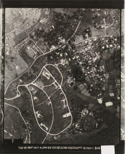 Aerial view of Sembawang Air Base with Sembawang Road running from left to top right of the photograph. Branching north from Sembawang road is Jalan Mata Ayer, with Sembawang School on its left. Also visible are Chye Kay village surrounded by fish ponds, and in the lower right corner, the mangrove swamps of Sungei Khatib Bongsu.