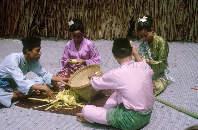 Malays weaving ketupat for wedding ceremony, Malaya
