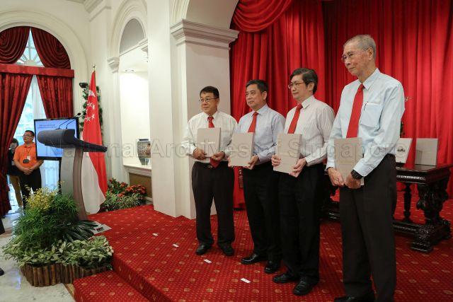 Director of Corrupt Practices Investigation Bureau (CPIB) Eric Tan (second from left) with former CPIB directors Mr Evan Yeo (right), Mr Soh Kee Hean and Chua Cher Yak, each with a copy of the coffee-table book published to mark the Bureau's 60th anniversary, posing for photographs at Istana State Room where a commemorative ceremony is held