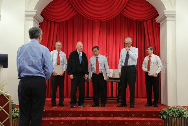 Mr Evan Yeo (left), Mr Lee Kuan Yew, Director of Corrupt Practices Investigation Bureau (CPIB) Eric Tan, Emeritus Senior Minister Goh Chok Tong and Mr Soh Kee Hean on the stage at Istana State Room during commemorative ceremony to mark CPIB's 60th anniversary. In the foreground with back to camera is Prime Minister Lee Hsien Loong.
