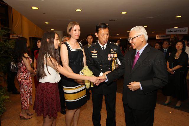 President Tony Tan Keng Yam with recipient of Public Administration Medal (Silver) (Military) and Chief of Staff Rear Admiral Tan Wee Beng from Republic of Singapore Navy and his family members at the reception during investiture of National Day awards at University Cultural Centre, National University of Singapore in Kent Ridge