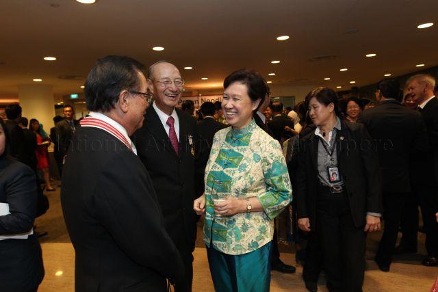 Madam Ho Ching, wife of Prime Minister Lee Hsien Loong, with recipient of Distinguished Service Order Medal and Chairman of DBS Group Holdings Peter Seah Lim Huat (left), recipient of Meritorious Service Medal and Chairman of CapitaLand Ltd Ng Kee Choe at the reception during investiture of National Day awards at University Cultural Centre, National University of Singapore in Kent Ridge