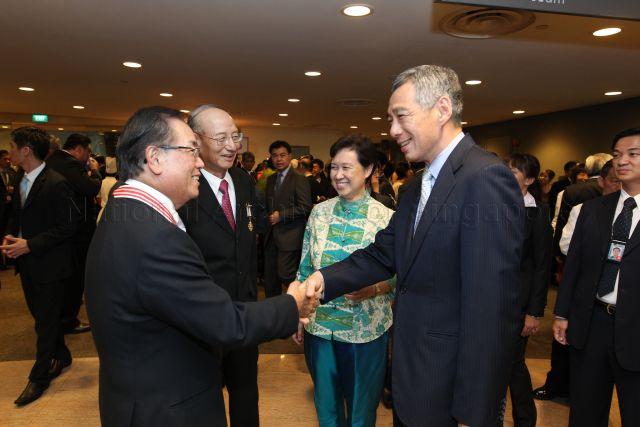 Prime Minister Lee Hsien Loong and his wife, Madam Ho Ching, with recipient of Distinguished Service Order Medal and Chairman of DBS Group Holdings Peter Seah Lim Huat (left), recipient of Meritorious Service Medal and Chairman of CapitaLand Ltd Ng Kee Choe at the reception during investiture of National Day awards at University Cultural Centre, National University of Singapore in Kent Ridge
