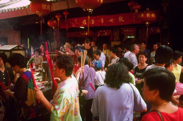 Devotees praying with joss sticks