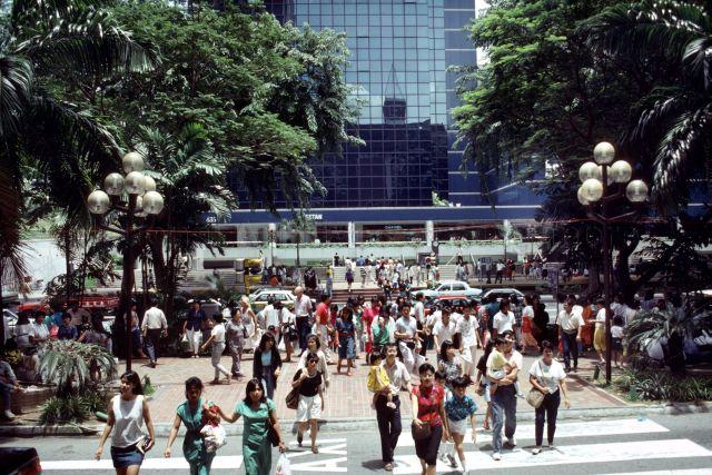 Crowd crossing road in front of Wisma Atria shopping mall at Orchard Road