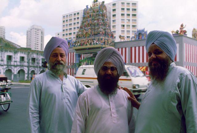 Three Sikh men in front of Sri Veeramakaliamman Temple in Little India