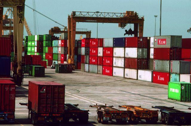 Loading and unloading shipping containers by cranes at a port