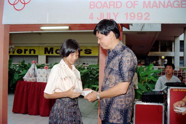 Guest of honour, member of People's Association (PA) Board of Management Colonel Tan Hong Huat presenting prize during PA Day celebrations held at PA Staff Club, Queen Street