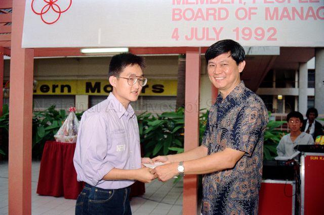 Guest of honour, member of People's Association (PA) Board of Management Colonel Tan Hong Huat presenting prize during PA Day celebrations held at PA Staff Club, Queen Street