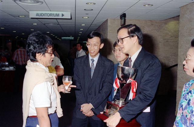 Winners of the SPH VisQuiz, from right, Dr Chang Tou LIang (holding trophy), Dr Lim Fang Kiat and Dr Nelson Chua Ping Ping in conversation with Ministry of Education Information Officer (Public Relations Branch) Ms Kalynani Kausikan at World Trade Centre Auditorium. The general knowledge quiz is jointly organised by Singapore Press Holdings (SPH) and the People's Association (PA).