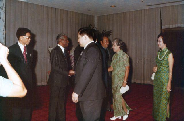 Minister for Finance Hon Sui Sen (hidden) and Mrs Hon being greeted upon arrival at Shangri-La Hotel to attend 10th anniversary dinner of Neptune Orient Lines (NOL)