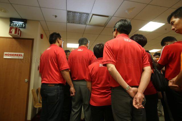 Prime Minister Lee Hsien Loong (second from left) speaking to the media during his visit to Tan Tock Seng Hospital on the first day of Chinese New Year 2013