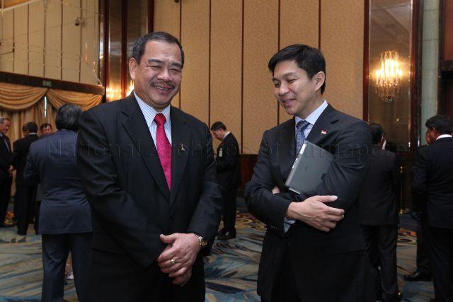Singapore Senior Minister of State for National Development Tan Chuan Jin (right) speaking to Malaysian Minister for Transport Kong Cho Ha at Singapore-Malaysia leaders' retreat at Shangri-La Hotel