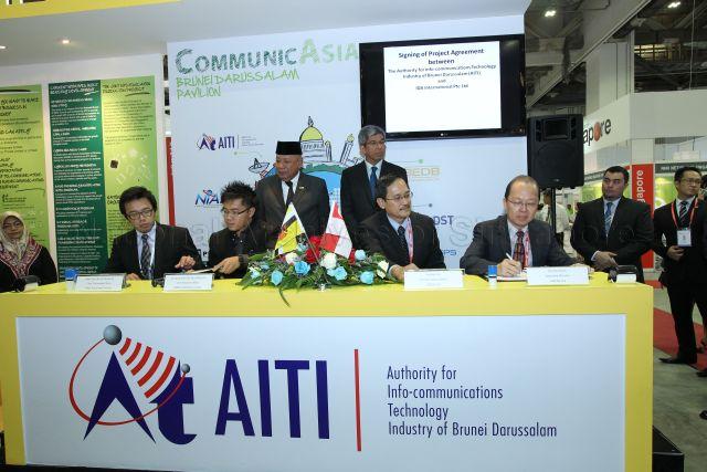Signing of Memorandum of Understanding between Brunei's PHMD Publishing Company Chief Executive Officer Mohd Khairi Pengiran Haji Metussin (seated second from left) and Singapore's LDR Pte Ltd Chief Executive Officer Png Bee Hin (seated second from right) at the Brunei Pavilion in CommunicAsia, an event incorporated under Infocomm Media Business Exchange (imbX) at Marina Bay Sands. Witnessing the signing are Brunei's Minister of Communications Yang Berhormat Pehin Orang Kaya Hamzah Pahlawan Dato Seri Setia Awang Haji Abdullah bin Begawan Mudim Dato Paduka Haji Bakar (standing, left) and Minister for Communications and Information Dr Yaacob Ibrahim (standing, right).