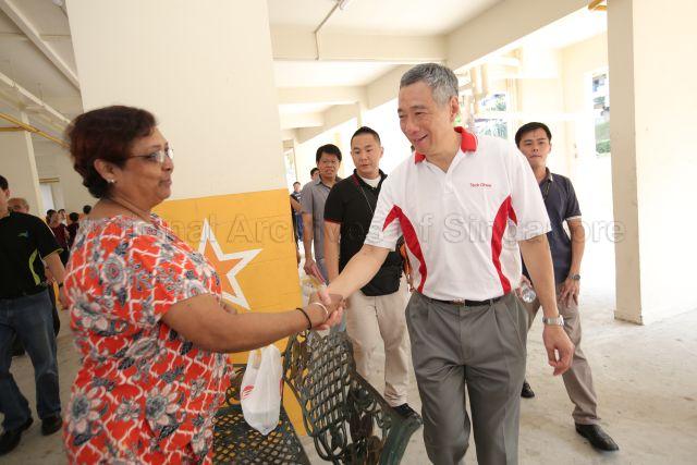 Prime Minister Lee Hsien Loong interacting with residents during distribution of masks to residents of rental flats in Blk 217 Ang Mo Kio Ave 1.