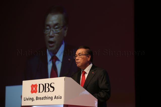 Development Bank of Singapore (DBS) Group Holdings and DBS Bank Chairman Peter Seah Lim Huat speaking behind a lectern while on stage during the DBS Asian Insights Conference 2013 held at Marina Bay Sands Convention Centre