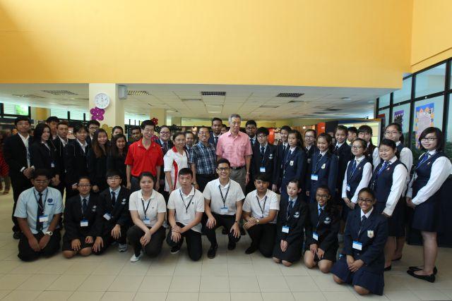 Group photograph of Prime Minister Lee Hsien Loong with Chief Executive Director of People's Association Ang Hak Seng, Principal of Chong Boon Secondary School Yeo Kuerk Heng with student participants during his visit to Internal Security Department (ISD) Heritage Centre mobile exhibition on security threats at the school in Ang Mo Kio Street 44