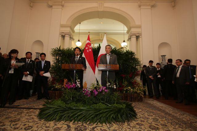 Prime Minister of Japan Shinzo Abe (standing on the right of Prime Minister Lee Hsien Loong) and PM Lee giving joint remarks at Istana during PM Abe's call on PM Lee at Istana