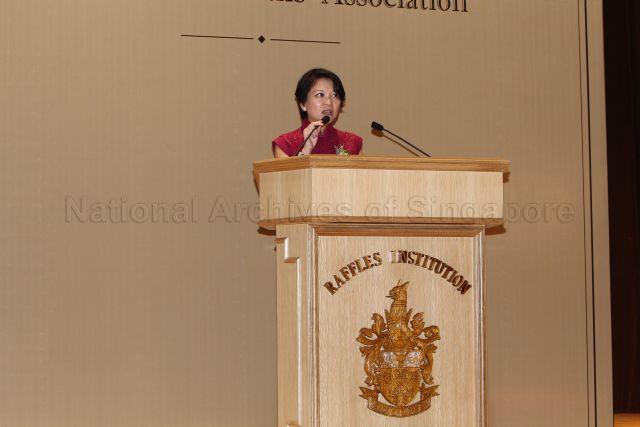 Principal of Raffles Institution, Lim Lai Cheng (wearing red dress) speaking on stage during Raffles Institution's 190th Anniversary Celebrations and the 90th Anniversary Dinner of the Old Rafflesians' Association held at Raffles Institution