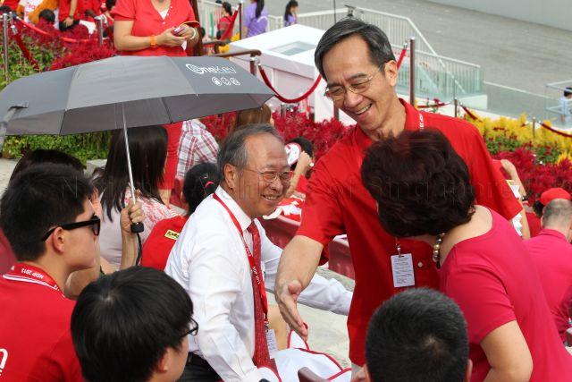 Former Member of Parliament Dr Tan Cheng Bock (wearing white attire) is attending National Day Parade 2013 at the Float @ Marina Bay.