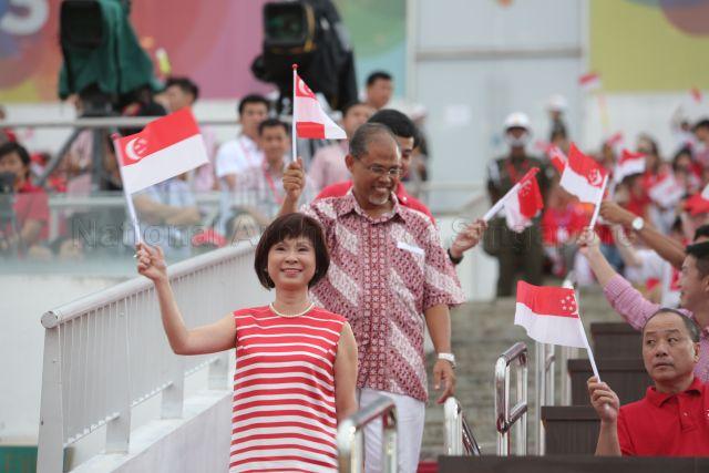 Minister of State for Health and Manpower Dr Amy Khor Lean Suan (centre), Senior Minister of State for Foreign Affairs and Home Affairs Masagos Zulkifli bin Masagos Mohamad (walking behind Dr Khor) and Aljunied Group Representation Constituency Member of Parliament Low Thia Khiang (seated first row, right) are attending National Day Parade 2013 at the Float @ Marina Bay.