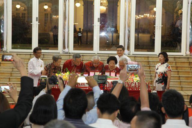 From left: Prime Minister Lee Hsien Loong's wife Madam Ho Ching, Prime Minister Lee Hsien Loong, President Tony Tan, First Lady Mrs Mary Tan, Emeritus Senior Minister Goh Chok Tong are blowing the candles on the birthday cake during National Day reception at Istana lawn. Emeritus Senior Minister Goh Chok Tong's wife Madam Tan Choo Leng is pictured on the far right.