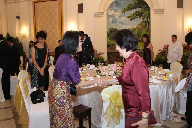 First Lady Mrs Mary Tan (right, side facing camera) is shaking hands with a guest at President's Scholarship Award Ceremony dinner at Istana.