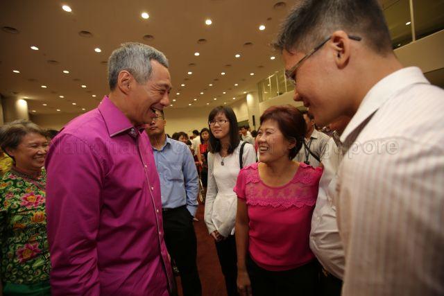 Prime Minister Lee Hsien Loong with Mrs Lim, who manages a vegetable stall at Block 409 Teck Ghee Market, and her family at the reception during National Day Rally at Institute of Technical Education (ITE) headquarters and College Central in Ang Mo Kio