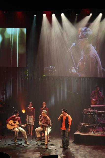 Attorney-General Steven Chong (seated 2nd from left) performing with a guitarist and singers at the Singapore Academy of Law Charity Concert. The concert is held at School of the Arts, Drama Theatre.