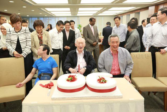 In the Members' Room at Parliament House after a parliament sitting, former Prime Minister Lee Kuan Yew, People's Action Party, Workers' Party, and Nominated Members of Parliament are celebrating former PM Lee's 90th birthday celebration. Seated are Professor Lee Wei Ling (daughter of former PM Lee), former PM Lee and Prime Minister Lee Hsien Loong (son of former PM Lee).