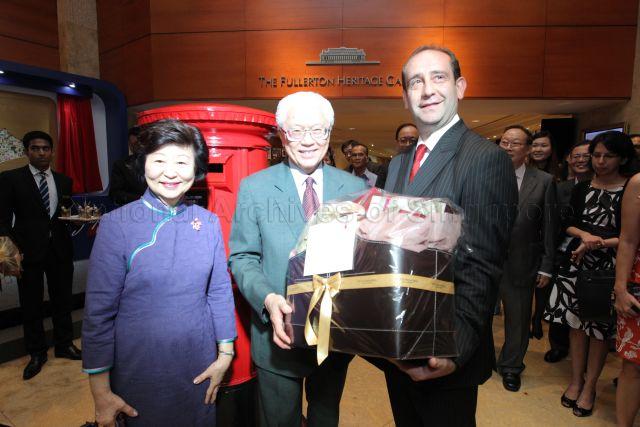 General Manager of Fullerton Hotel Cavaliere Giovanni Viterale presenting a gift to President Tony Tan and his wife Mrs Mary Tan, during Singapore Post "Gift to the Nation" presentation ceremony, held at Heritage Gallery of Fullerton Hotel.