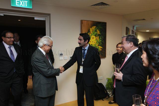 President Tony Tan shaking hands with Dr Raj Thampuran from Agency for Science, Technology and Research, at The President's Science and Technology Awards dinner, held at Gardens by the Bay. Looking on from the left is Minister (Prime Minister's Officer), Second Minister for Home Affairs and Trade and Industry S Iswaran