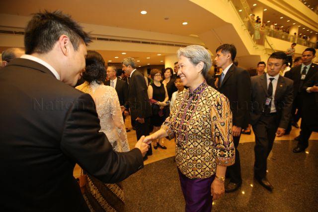 Madam Ho Ching, wife of Prime Minister Lee Hsien Loong, shaking hands with Henry Liew, son of recipient of Public Service Star award and founder of Bengawan Solo Madam Anastasia Tjendri, during investiture of National Day awards at University Cultural Centre, National University of Singapore in Kent Ridge