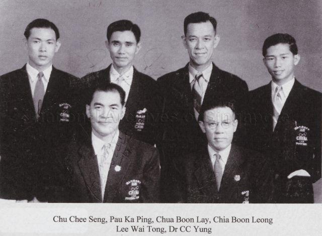 Group photograph of four of the players who played in the China Olympic Football Team at the World Olympics in London. Seated are the coach Lee Wai Tong, and Dr C C Yung, Manager of the China Olympic Football Team.