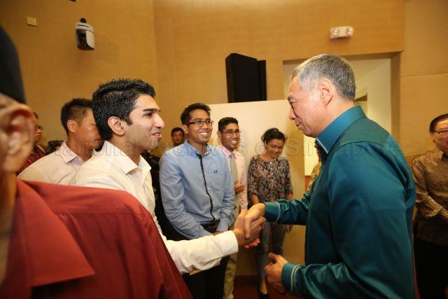 Prime Minister Lee Hsien Loong speaking to Afzal Ali, a law graduate from National University of Singapore (NUS), at the auditorium, Institute of Technical Education (ITE) headquarters and College Central in Ang Mo Kio, during National Day Rally