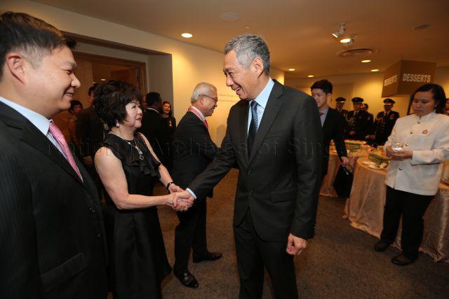 Prime Minister Lee Hsien Loong greeting Mrs Chua Thian Poh, wife of recipient of Distinguished Service Order Medal and President of Singapore Federation of Chinese Clan Associations Chua Thian Poh, at the reception during investiture of National Day awards at University Cultural Centre, National University of Singapore in Kent Ridge