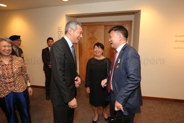 Prime Minister Lee Hsien Loong and his wife, Madam Ho Ching, with recipient of Meritorious Service Medal, Member of Legal Service Commission and Chairman of Shell Singapore Lee Tzu Yang, and his wife at the reception during investiture of National Day awards at University Cultural Centre, National University of Singapore in Kent Ridge