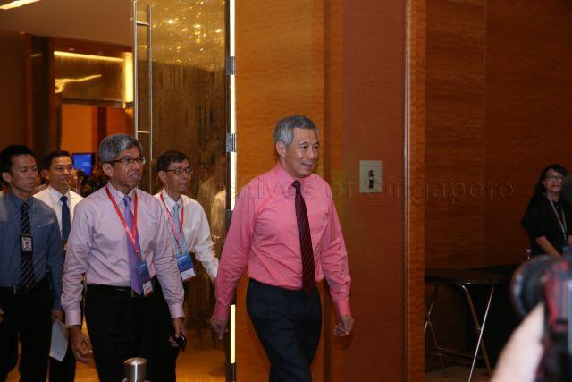 Prime Minister Lee Hsien Loong entering Jasmine Ballroom at Sands Expo and Convention Centre in Marina Bay Sands to launch Smart Nation vision in conjunction with National Infocomm Awards. Accompanying him are Minister for Communications and Information Associate Professor Dr Yaacob Ibrahim and Head of Civil Service Peter Ong.